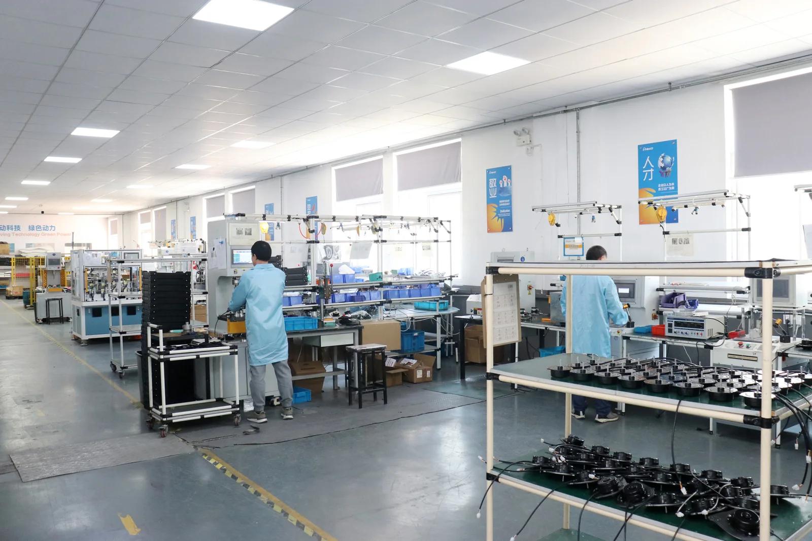 E-POWER technician working on the blower production line
